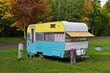 Vintage travel trailer camping in the forest at the Union Bay camp ground Porcupine Mountains State Park, Michigan