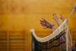 © Zamrznuti tonovi - Woman hands at the volleyball net in an indoor court