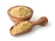 Dry mustard powder in wooden scoop and bowl