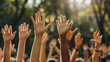 © Erika - personas en equipo manisfestandose alzando sus manos para ejercer su voto y su participacion la democracia voluntarios