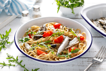 Poster - Whole grain pasta with sardines, tomato and arugula. Italian Sicilian cuisine.