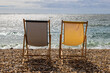 Two empty deckchairs on the beach, at Lyme Regis on the Dorset coast