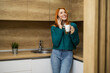 Woman Enjoying Coffee in Kitchen