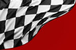 Checkered black and white racing flag on red background