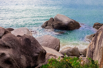 Wall Mural - View of large rocks along the shore of the South China Sea. Sky Grottoes Park, Sanya, China