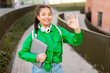 © Prostock-studio - Smiling Young Girl in Green Jacket Giving Okay Gesture
