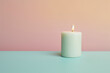 Minimalist composition: Lit candle with heart stone on dual-tone background