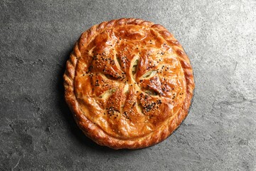 Tasty homemade pie with filling on grey table, top view