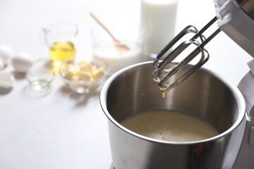 Canvas Print - Making dough in bowl of stand mixer on white table. Space for text