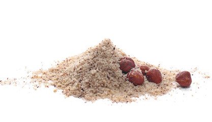 Wall Mural - Hazelnuts ground pile and whole grains isolated on white, side view
