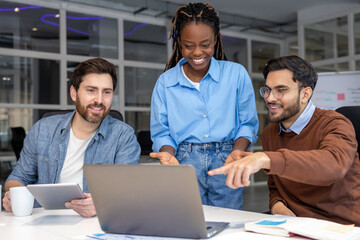 Happy businesspeople collaborating on new project in office