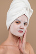 Young woman with rejuvenating mask on face