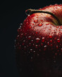 Close up of a fresh red apple with water droplets on a dark background