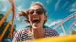 Face of a happy cheerful attractive woman in sunglasses laughing, riding a rollercoaster in an amusement park in summer