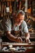 © Fotograf - A man working on a piece of wood in a workshop. Ideal for showcasing craftsmanship