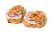 Tasty canapes with salmon, cucumber, radish and cream cheese isolated on white