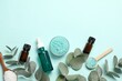 Aromatherapy products. Bottles of essential oil, sea salt and eucalyptus branches on light blue background, flat lay