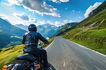 Wall Mural - A man riding a motorcycle down a scenic mountain road. Perfect for adventure and travel concepts