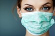 Close-up image of a female medical professional wearing a surgical mask, emphasizing her eyes and demonstrating healthcare safety protocols during a pandemic