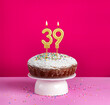 Lighted birthday candle number 39 - Birthday card on pink background