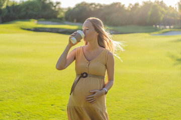 pregnant woman enjoys a cup of coffee outdoors, blending the simple pleasures of nature with the comforting warmth of a beverage during her pregnancy