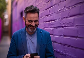 photo of a happy man in a casual business attire looking at his phone and smiling