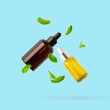 Essential oil or serum in glass bottle falling with leaves isolated on light blue background.