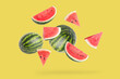 Falling watermelon on yellow background