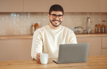Poster - Man Wearing Eyeglasses Sitting at Table With Laptop