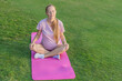 Energetic pregnant woman takes her workout outdoors, using an exercise mat for a refreshing and health-conscious outdoor exercise session