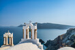 Santorini village bell towers against Aegean Sea. Greece