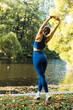 View from the back of Young woman doing yoga exercise outdoor in the park, sport yoga concept