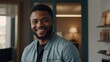© VistaVisions - Smiling cheerful young adult african american ethnicity man in casual attire looking at camera standing at home office background. Happy confident black guy headshot face front close up portrait