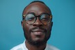 © Rasheeda - Happy african american man Smile against blue background