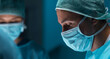 Team of medical doctors performs surgical operation in modern operating room using high-tech technology. Surgeons are working to save the patient in the hospital. Medicine, health and science.