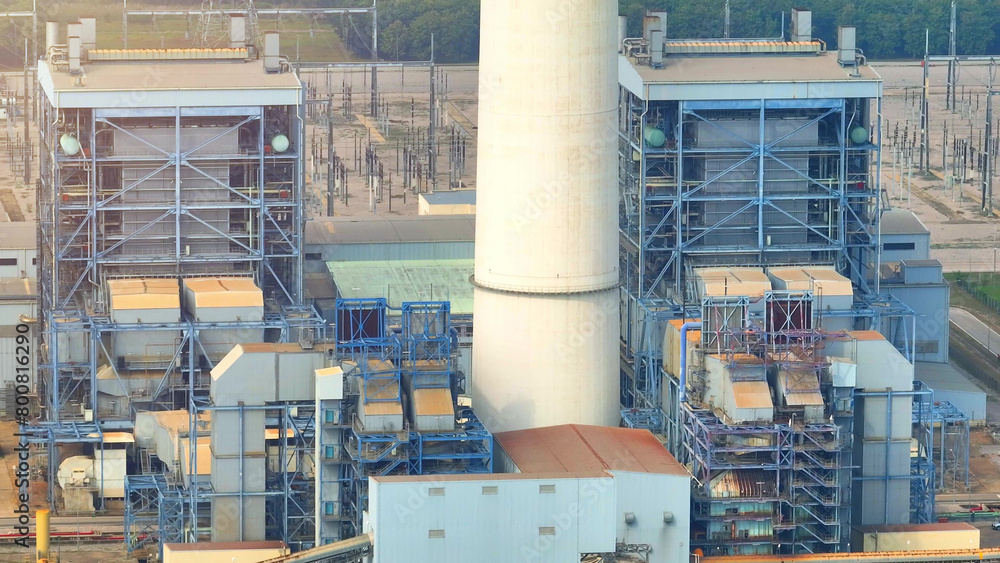 A thermal power plant generates electricity by burning fossil fuels ...