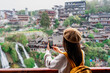 Young female tourist enjoying beautiful landscape at the Furong old Town, The famous tourist destination at Hunan Province, China