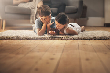 Kids, video and watching with tech on floor for digital education, ebook and learning in house. Boy, girl and tablet on ground for cartoon, children story and movie or virtual gaming app in home