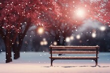Snowy Park Bench Under Bare Red Trees And Falling Snow