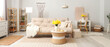 Stylish living room with sofa, coffee table and bouquet of narcissus flowers