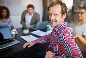 Leinwandbilder - Man, office and portrait with team at desk for strategy with meeting for research with smile. Working, collaboration and briefing or project with plan for hustle with workforce in Sweden with pride