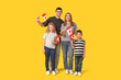 © Pixel-Shot - Happy family with flags of Canada on yellow background