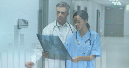 Canvas Print - Image of data processing over diverse doctors with x ray