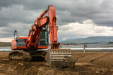 Fototapeta Uliczki - Excavator building a road in a site construction