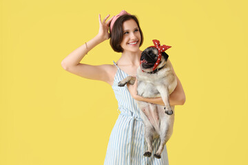 Poster - Pretty young woman with cute pug dog on yellow background