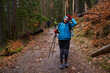 HIkers with backpacks on a trail in a rainy day