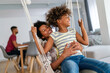 Family concept. Happy african american mother and daughter spendig fun time together at home