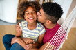 Happy african american single dad spends happy moments with his daughter. Family love concept