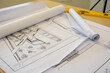 Architectural building plan or house engineering drawing in construction lies on the table.