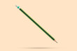 Green pencil isolated on brown background close up